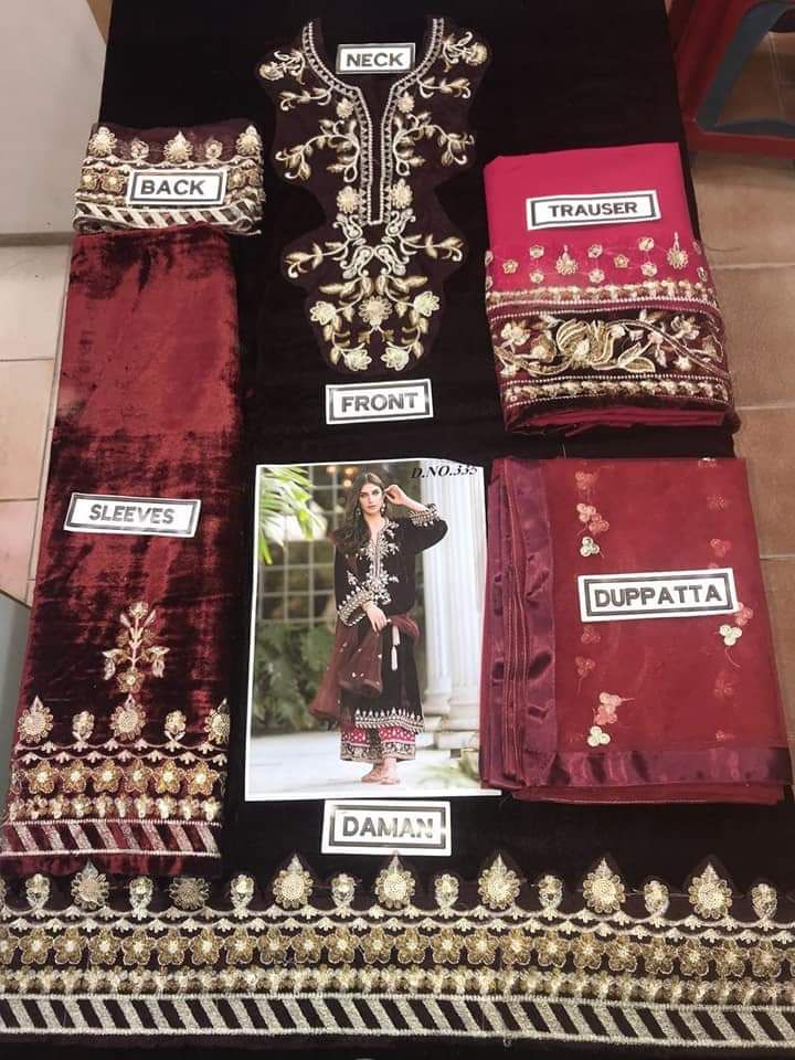 Embroidered fabric set with labels for different parts of a garment, displayed on a tiled floor.
