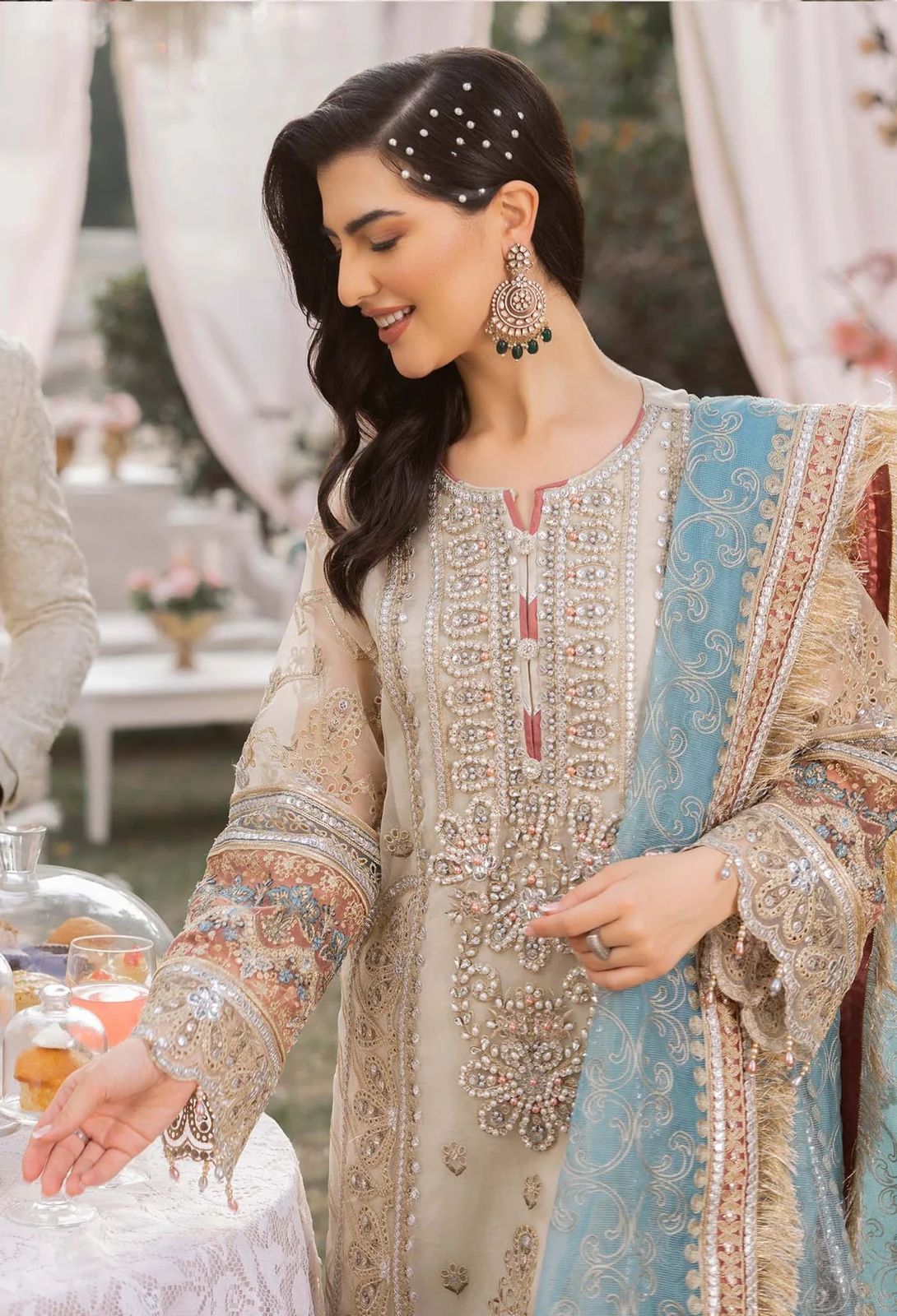 Woman in an embroidered traditional outfit with a blurred background