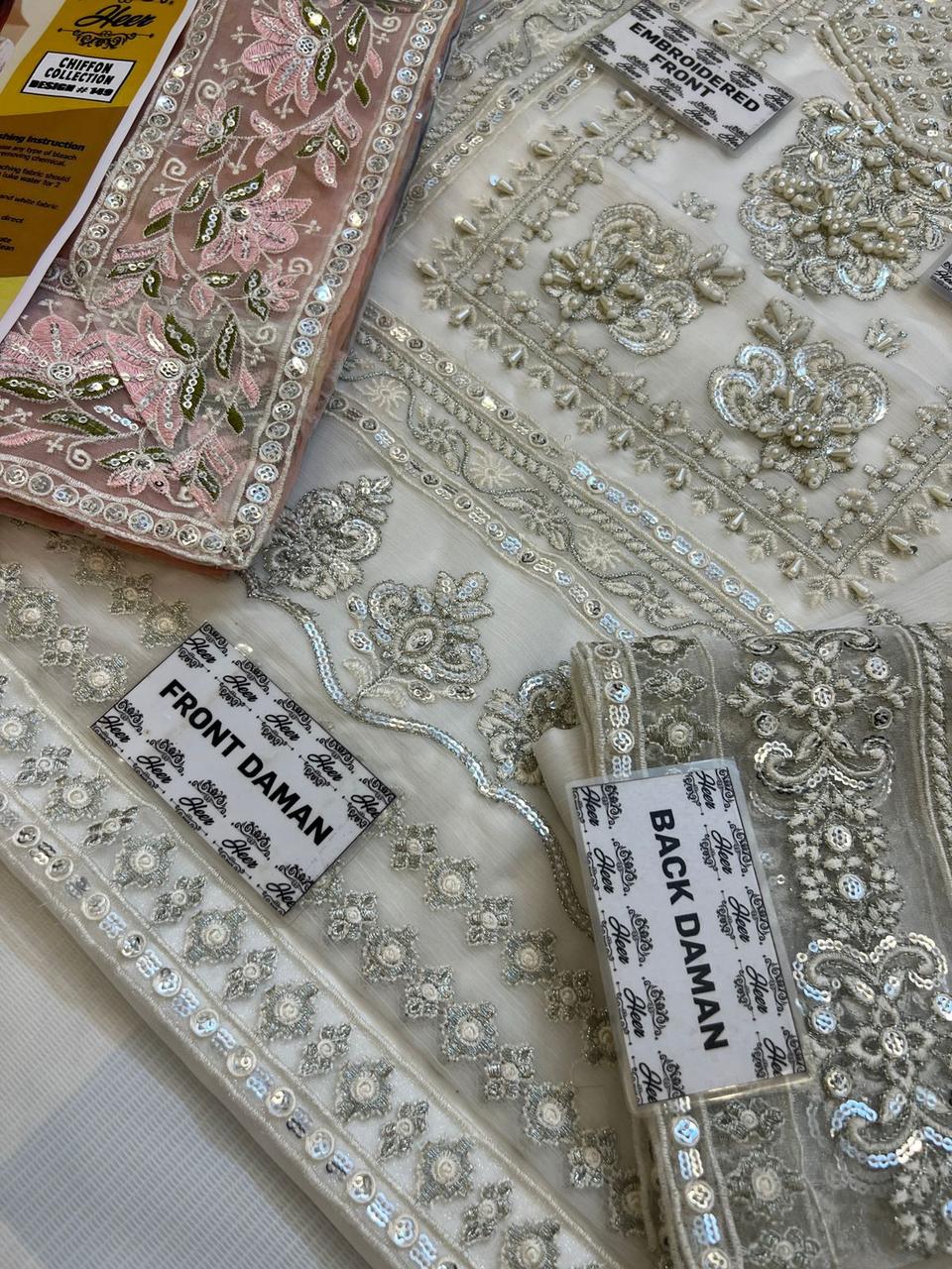 Decorative fabric with intricate patterns and embellishments on a flat surface.