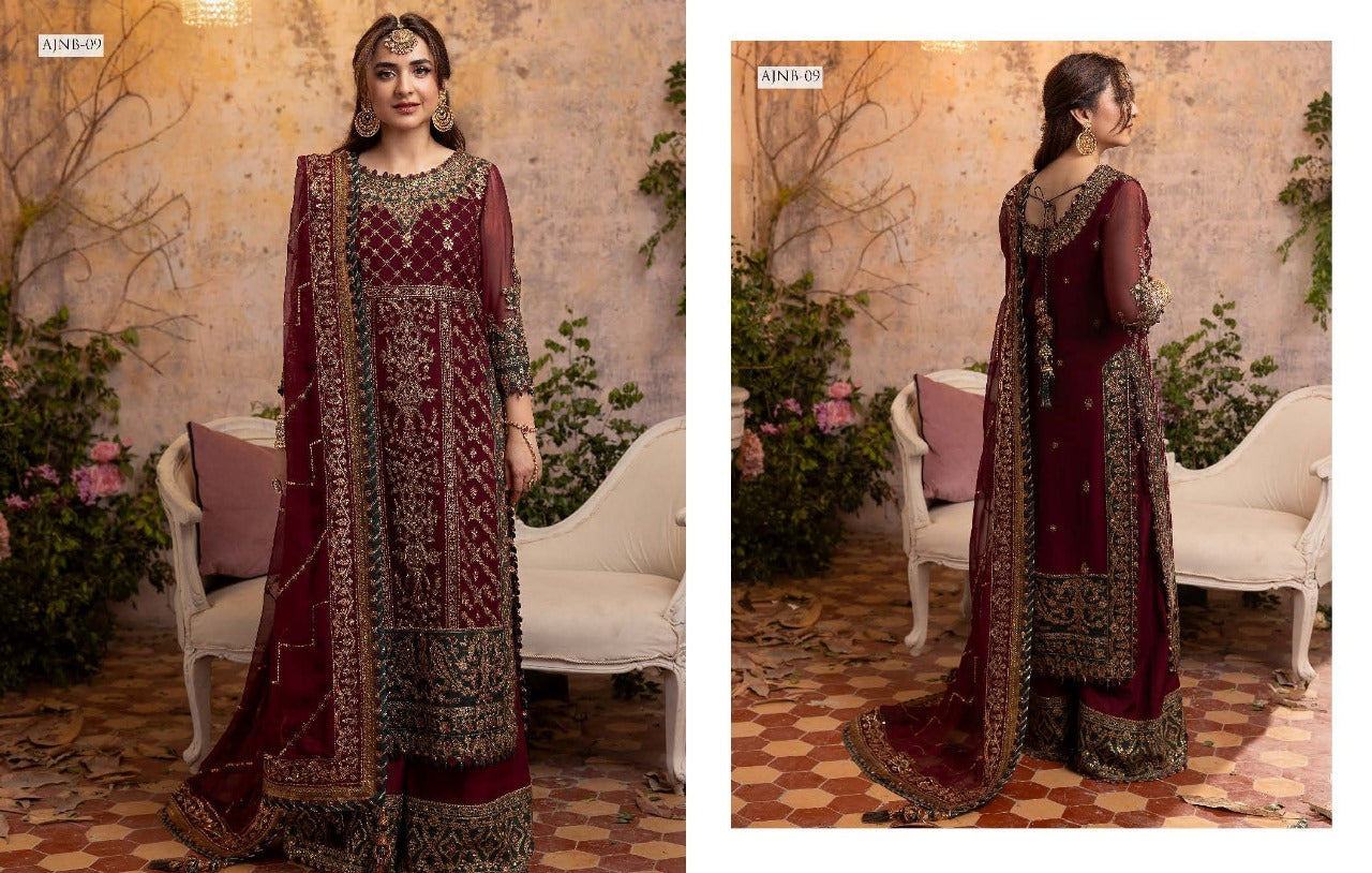 Maroon Asim Jofa Wedding embroidered traditional outfit with matching dupatta in a decorated indoor setting.