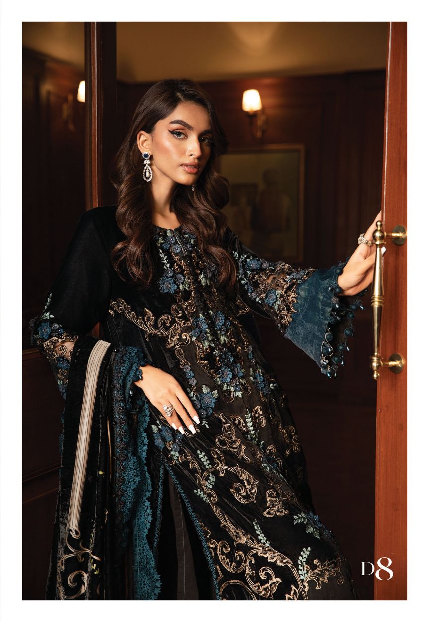 MAria b Palachi VElvet Dress Most Demanded an elegant black and blue embroidered outfit standing in a doorway.