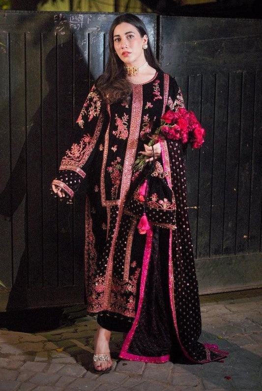 Aneela's New Black Pink BEautiful embroidered traditional outfit standing against a dark background.