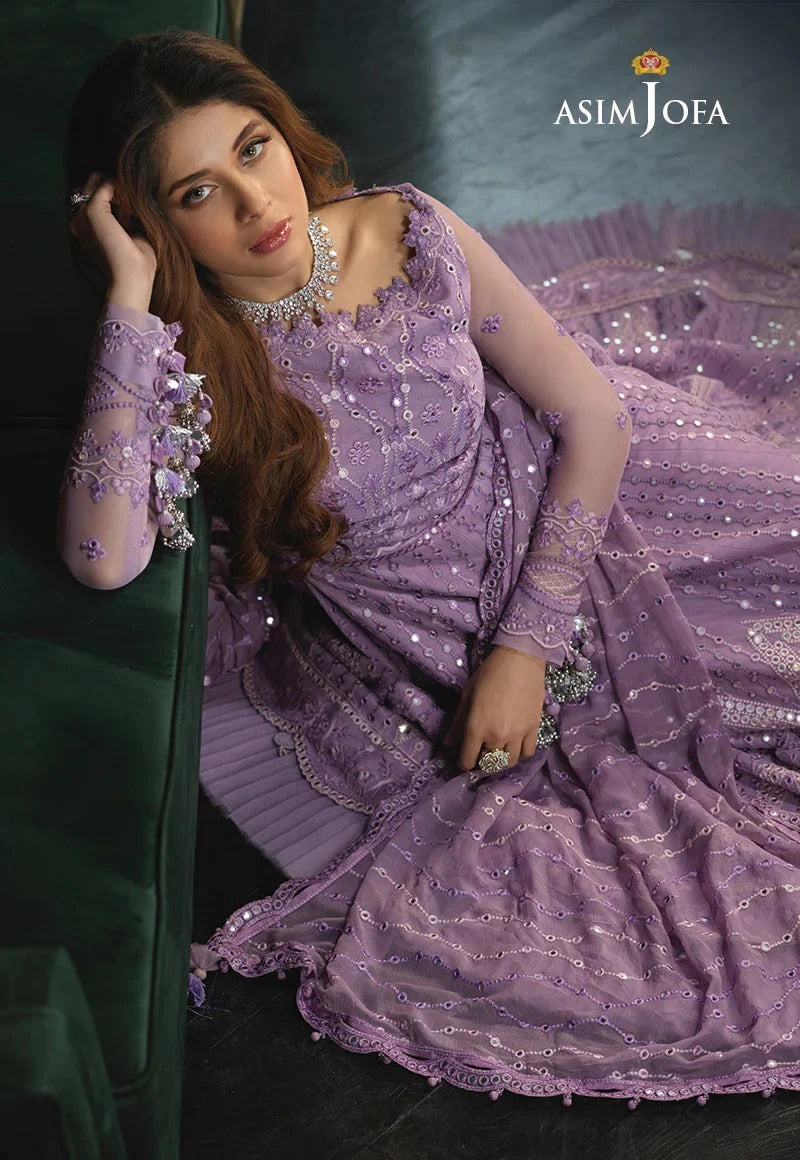 Woman in a purple embroidered dress with 'Asim Jofa' branding.