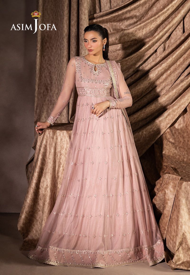Woman wearing a pink Asim Jofa MAxi against a textured brown background