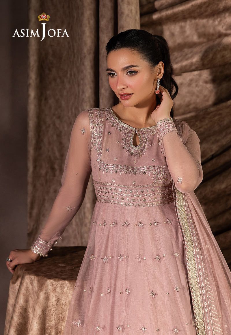 Woman wearing a pink embroidered dress with 'ASIM JOFA' branding.