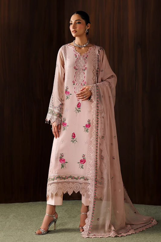 Woman wearing a light pink embroidered traditional outfit against a dark background