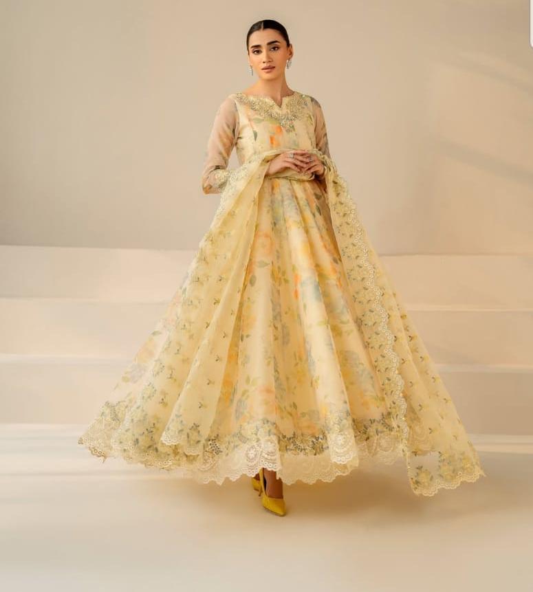 Woman wearing a floral dress with a plain background