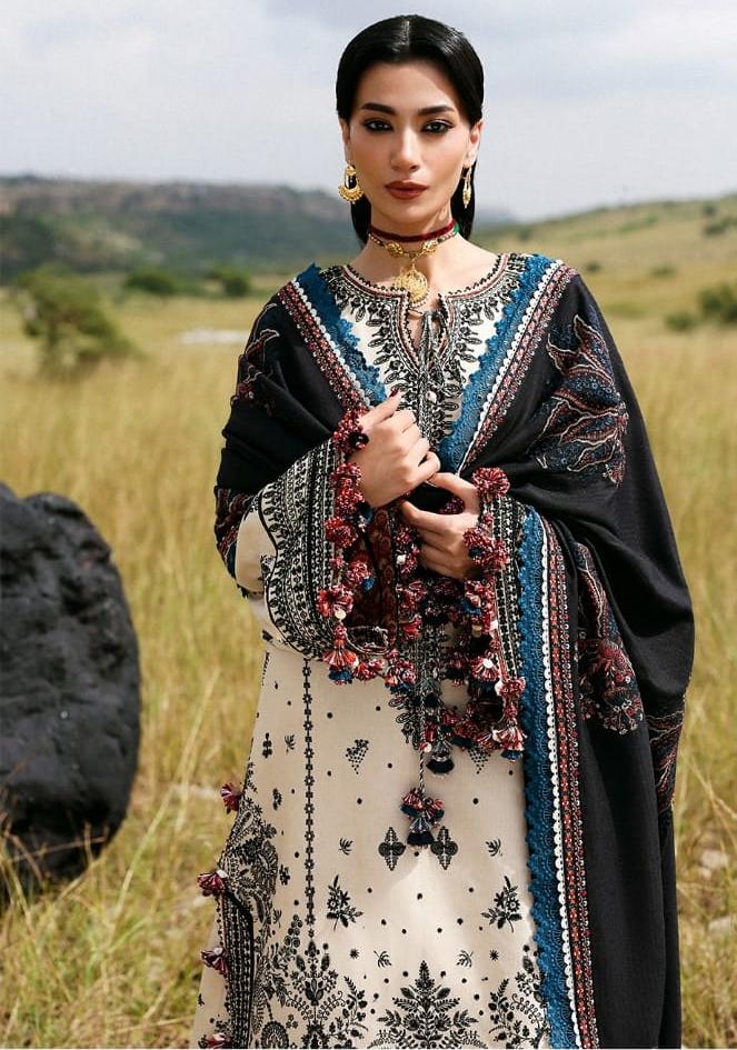 Woman wearing a traditional outfit with intricate patterns in a natural setting