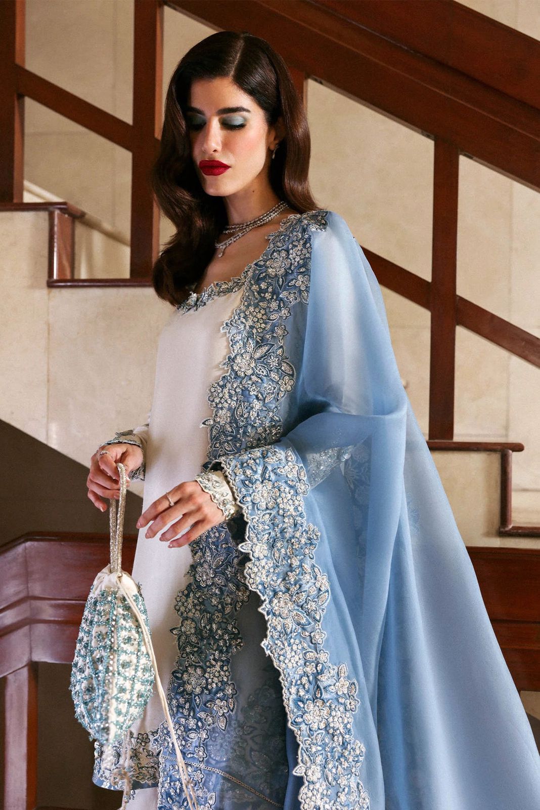 Hussain Rehar Wz-02 Sheesha Silk Heavy Adda Work With Clutch 2025traditional outfit with a blue dupatta standing indoors.