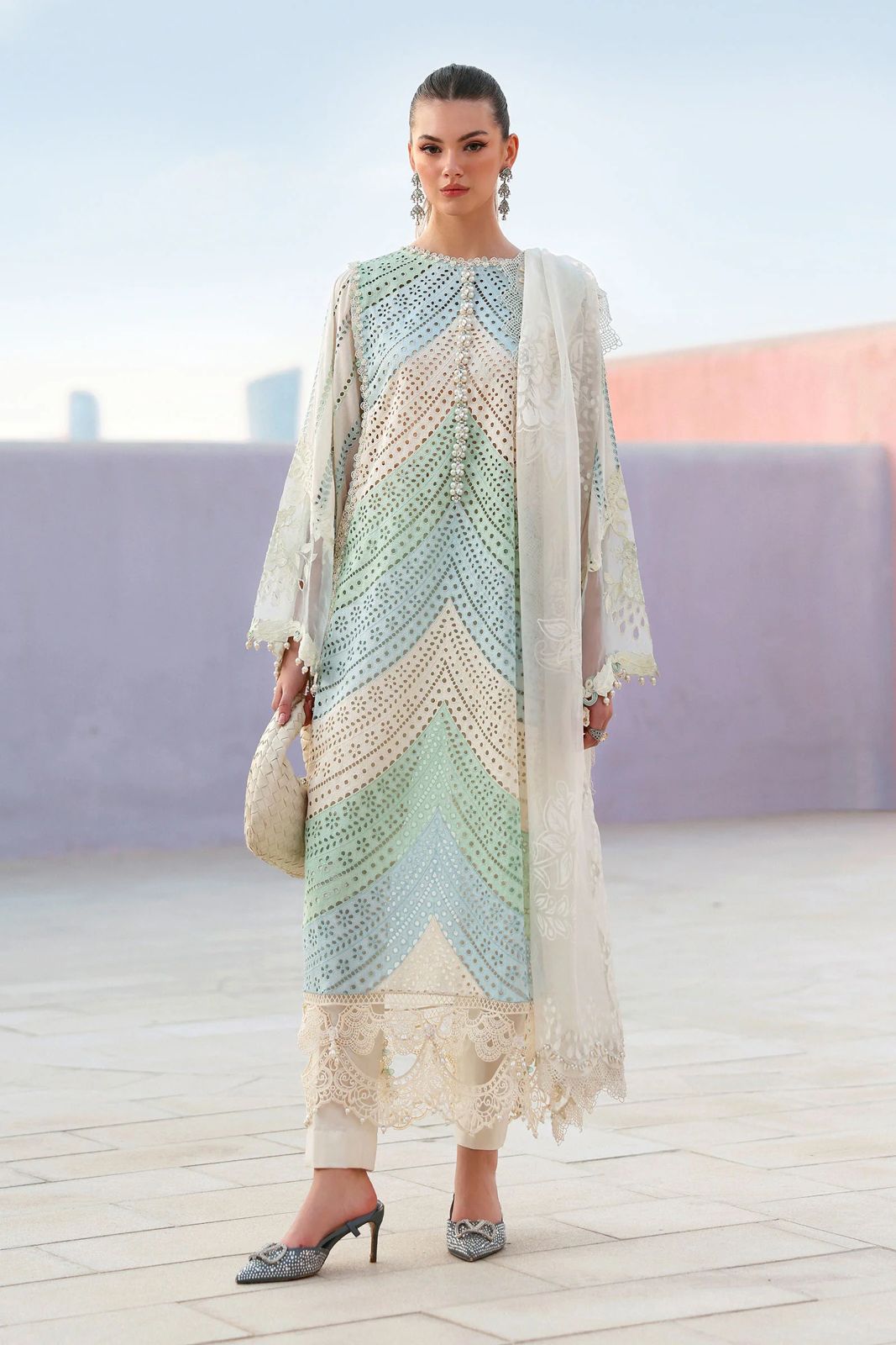 Woman wearing a colorful traditional outfit with a white background