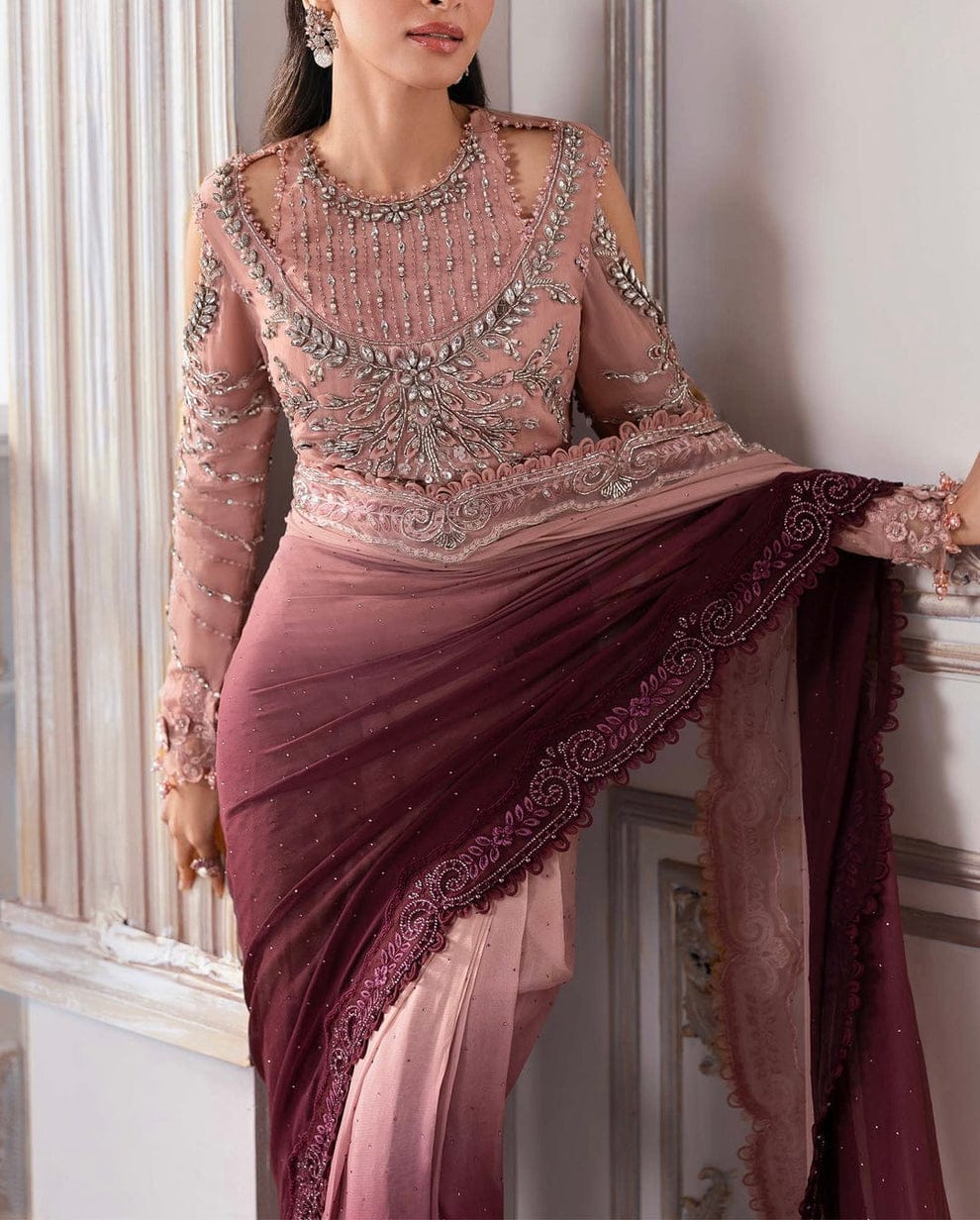 A woman models an embellished Indian ethnic outfit featuring a dusty pink long-sleeve embroidered blouse and a matching draped skirt in a deep plum purple, with a matching sheer dupatta.