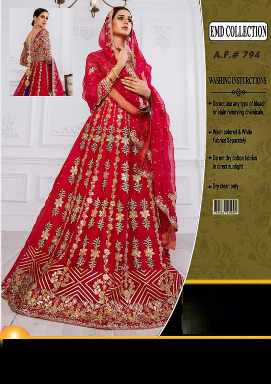 Red embroidered traditional outfit with gold details on a white background