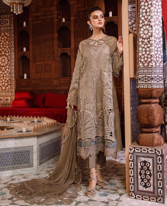Woman in a traditional outfit standing in an ornate room with intricate decor.