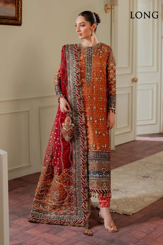 Jazmin Bridal Wear PAkistani Dress Woman in a traditional embroidered outfit standing in an elegant room with 'LONG' branding.
