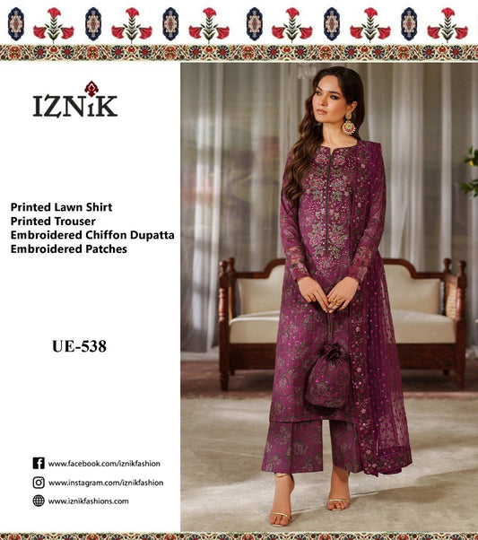 Woman wearing a purple embroidered outfit with Iznik branding on a white background.